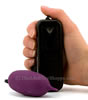 Cyberskin Flicker Vibrating Egg holding the controller